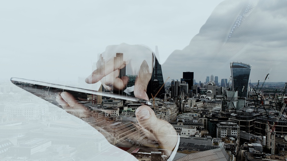 Double exposure of businessman working with new modern computer and london city background as concept.jpeg